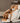 Massage chair in a room with a shelf and decorative items.